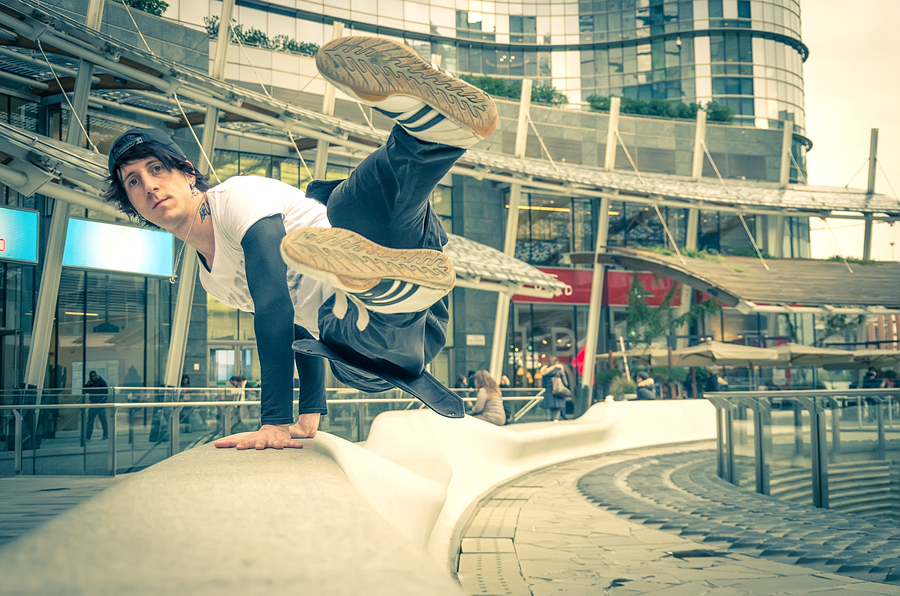 Parkour athlete jumping over a handrail - Free runner performing tricks in a urban settlement - Parkourfree runningyouthsport and lifestyle concept