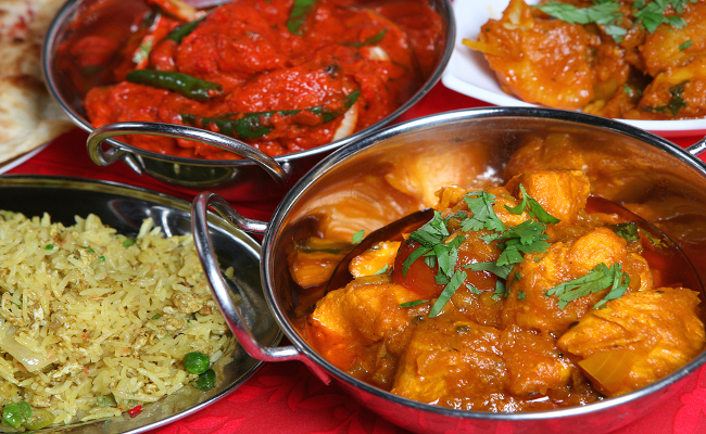 Indian curry meal with rice nan and begetables