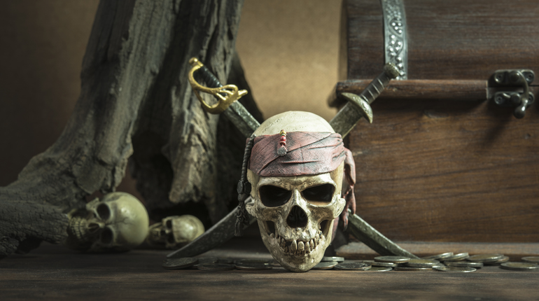 pirate skull with two swords and coffer over two head of human background still life style pirate concept for halloween